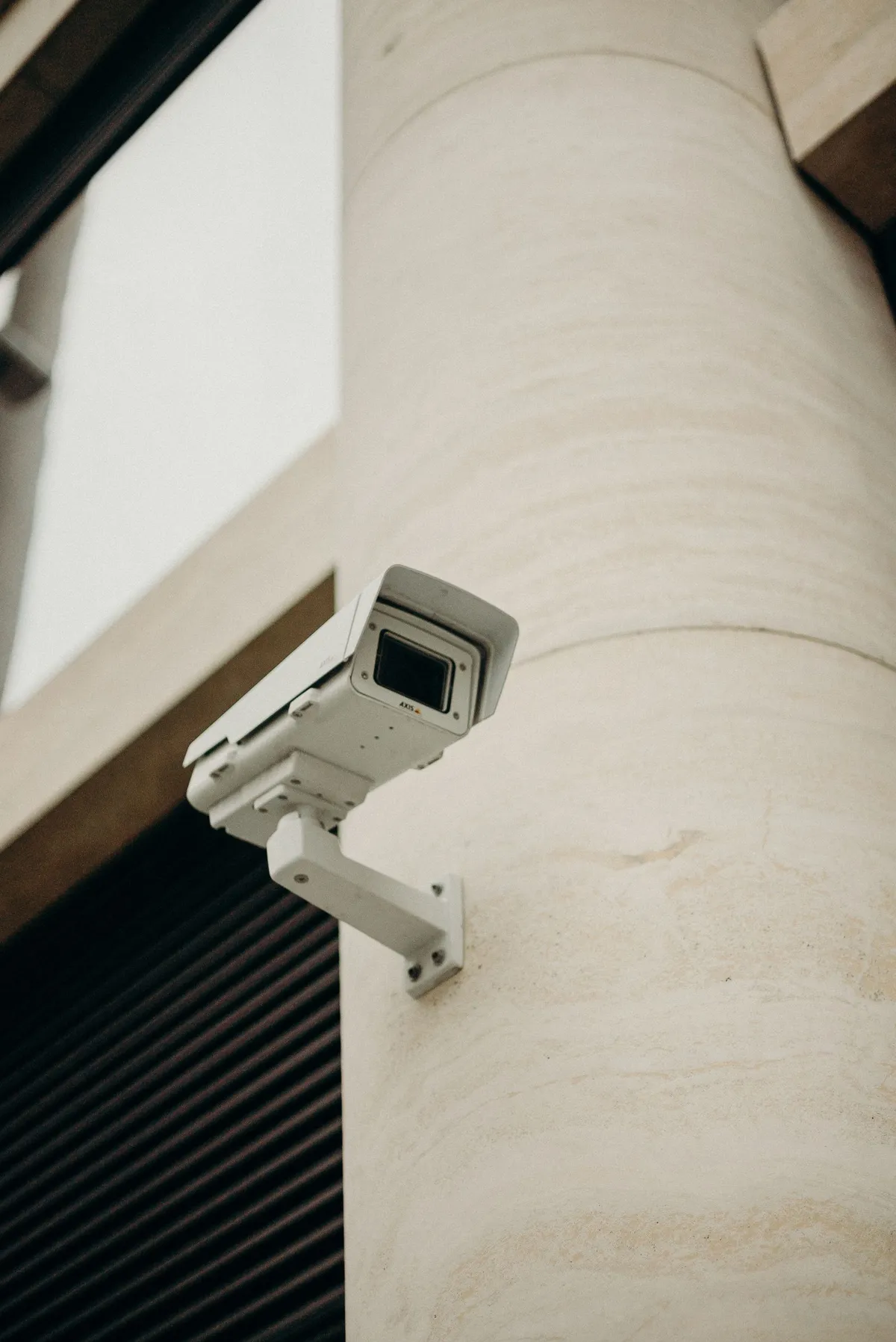 Illustrative stock photograph of a security camera mounted outside a building